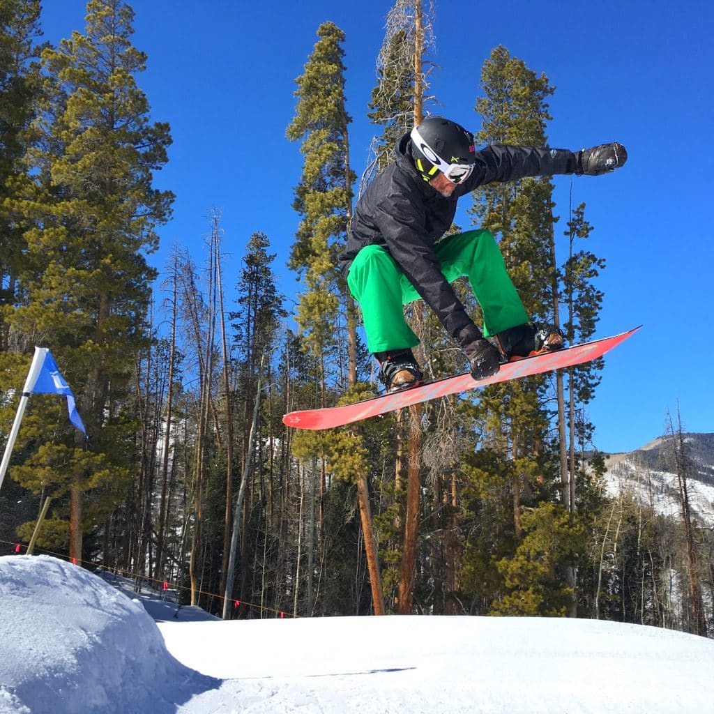 mick doing a snowboard jump